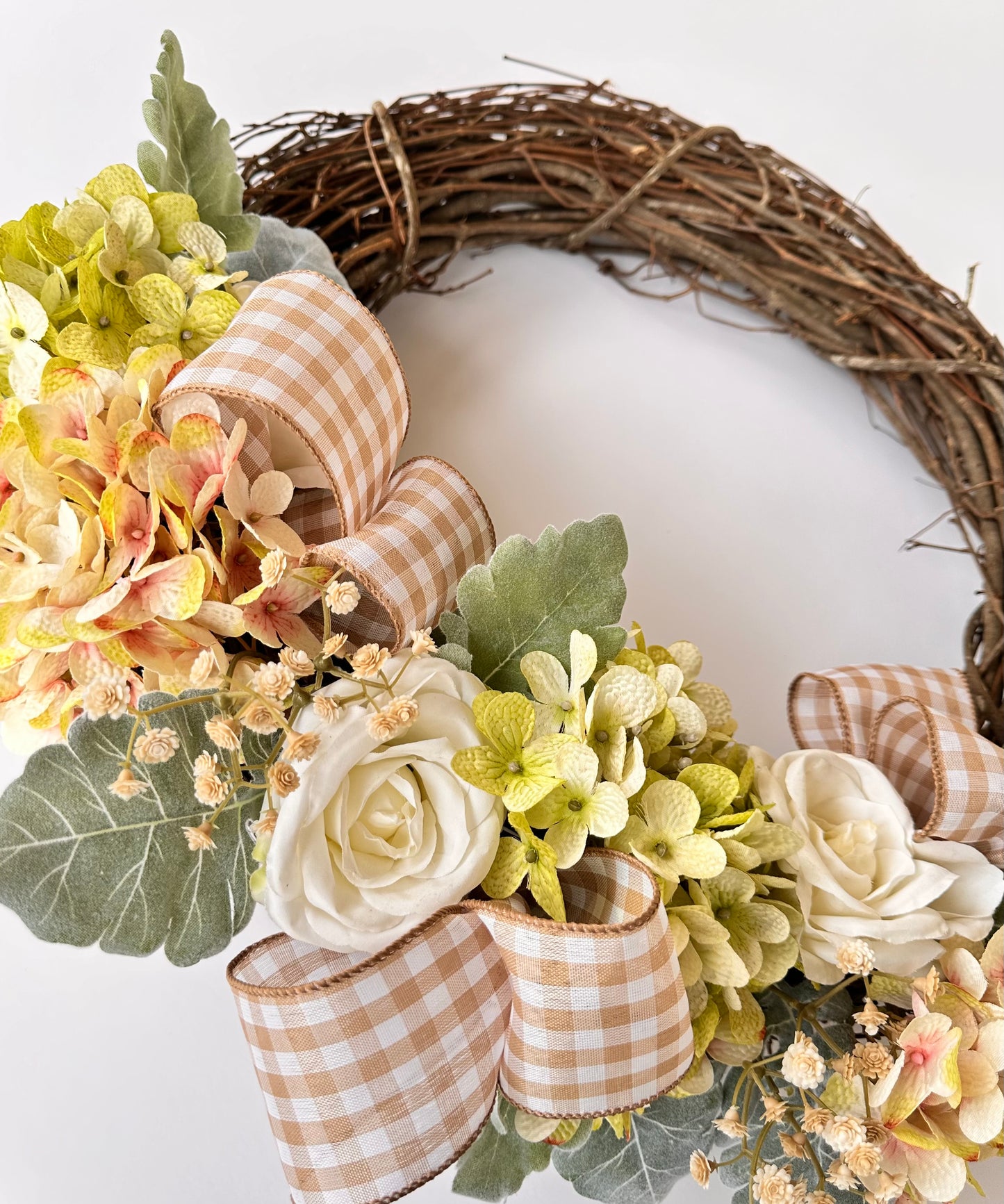 18 in. Vine Wreath with Artificial Soft Toned Hydrangeas and White Roses, with Checkered Ribbon